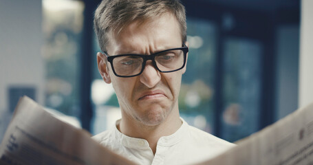 Man reading bad news on the newspaper