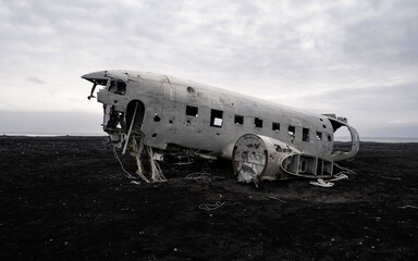 The wreckage of an abandoned DC 3 plane on a black ocean beach in Iceland. Popular attractions in Iceland. Solheimasandur plane crash, Black sand Beach 