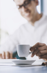 Man sitting at desk and drinking coffee
