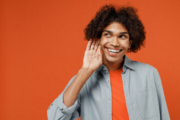 Young curious nosy student black man 50s wearing blue shirt t-shirt look aside try to hear you...