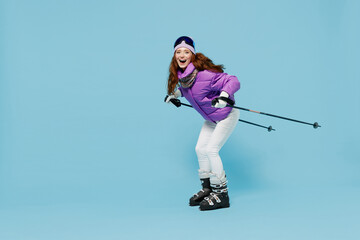Full size side view skier fun cool caucasian woman wear warm purple padded windbreaker jacket...