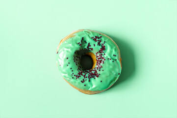 Donut with colored glaze close-up on a colored background 