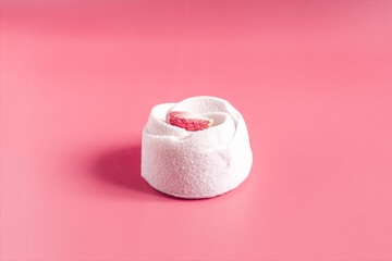 Obraz na płótnie Canvas Fragrant strawberry shortcake with sponge cake on a red background close-up