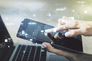 Multi exposure of abstract financial graph with world map and hand working with a digital tablet on background, financial and trading concept