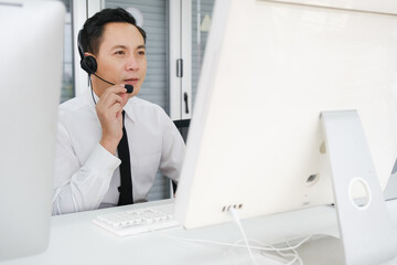 asia man working call center operator with headset in office or workplace