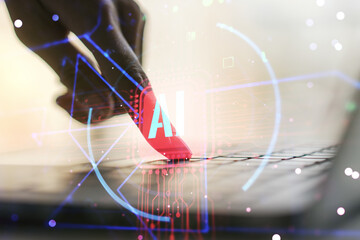Double exposure of creative artificial Intelligence abbreviation with hand typing on computer...