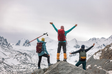 Three happy female hikers in mountains