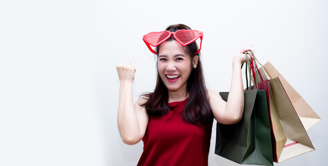 Asian beautiful woman are raise hand and hold shopping bag  with happiness  and enjoy . Shopping mania. A Black Friday.