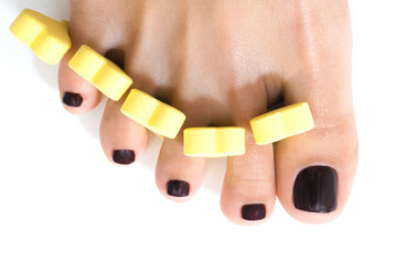 beautiful female feet with shellac coating on the nails, on a white isolated background. finger...