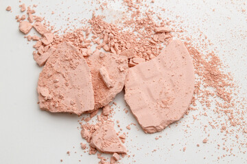 Face powder. Broken pieces of cosmetic powder. Cosmetic smear.