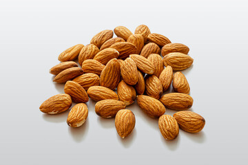 Handful of almonds on a light background