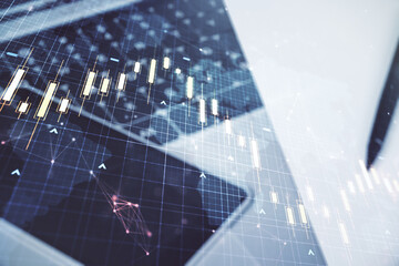Multi exposure of abstract creative financial chart with world map on laptop background, research and analytics concept