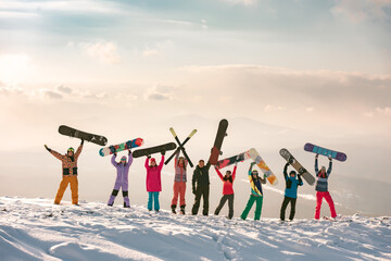 Big group of diverse skiers and snowboarders at ski resort