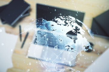 Multi exposure of abstract software development hologram with world map on laptop background, global research and analytics concept
