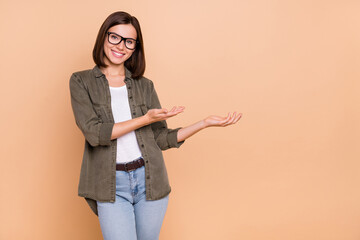 Photo of reliable lady hands demonstrate empty space wear specs khaki shirt isolated beige color background