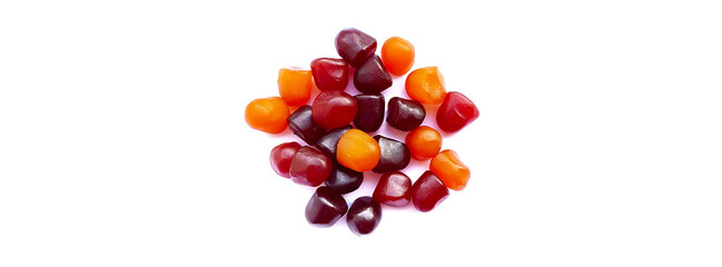 Close-up texture of red, orange and purple multivitamin gummies on white background. Healthy lifestyle concept