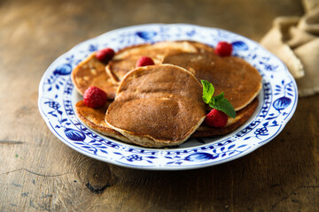 Traditional homemade pancakes with raspberry