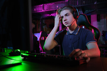Professional young caucasian gamer playing online on his PC. He upset because of losing the game © nazarovsergey