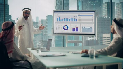 Emirati Businessman Holds Meeting Presentation for International Business Partners. Manager Uses Whiteboard with Growth Analysis, Charts, Statistics and Data. Saudi, Emirati, Arab Office Concept. - Powered by Adobe