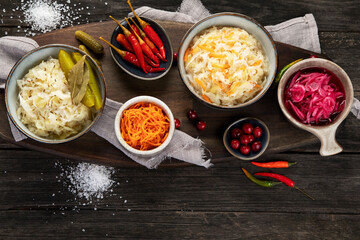 Pickled vegetables on wooden background. Salting vegetables.