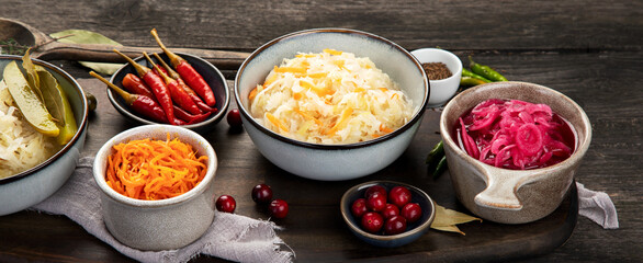 Pickled vegetables on wooden background. Salting vegetables.