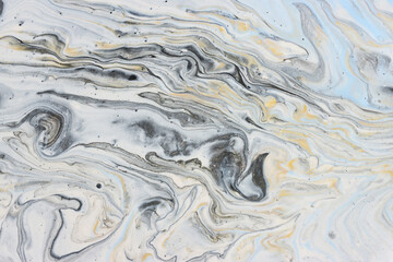 art photography of abstract marbleized effect background with gold, gray, black and white creative colors. Beautiful paint.