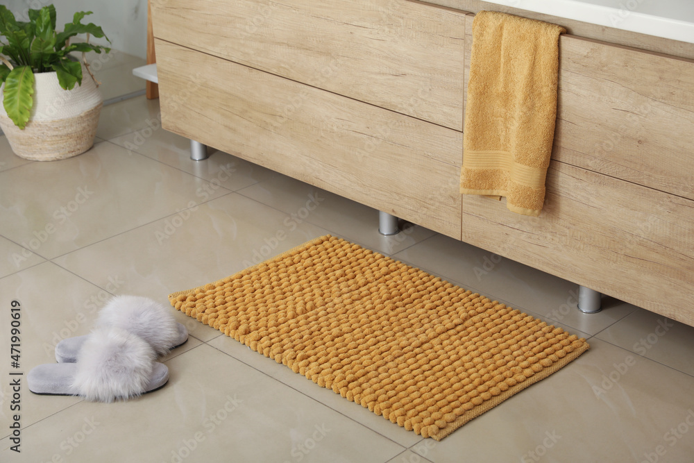 Wall mural soft orange bath mat and slippers on floor indoors