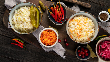 Pickled vegetables on wooden background. Salting vegetables.