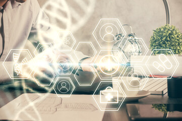 Double exposure of man's hands holding and using a phone and DNA drawing. Medical education concept.