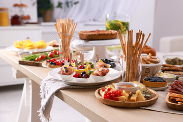 Dishes with different food on table in room. Luxury brunch