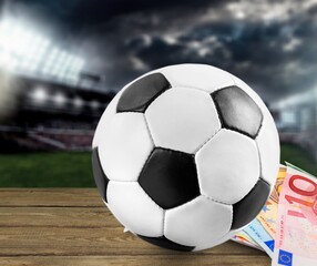 Fototapeta na wymiar Dollars and the soccer ball. Sports betting, soccer betting, gambling, bookmaker, big win