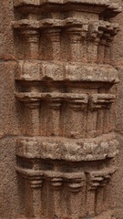Beautiful sculptures can be seen in the gates of the tower of the temple. Its one side wall. Carved stone sculpture. This is an unfinished temple.