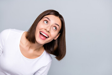 Photo of funny brunette young lady look empty space wear shirt isolated on grey color background