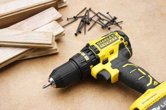 Stanley's new cordless screwdriver on wood background.