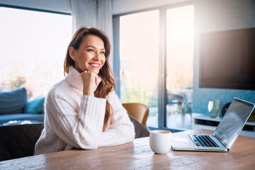 Attractive woman sitting at desk and ready for working from home