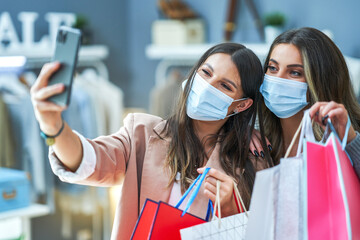 Girls on shopping wearing masks taking selfie