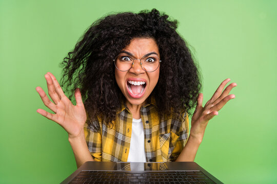 Photo of impressed valume hairdo young lady look laptop yell wear eyewear plaid shirt isolated on green background