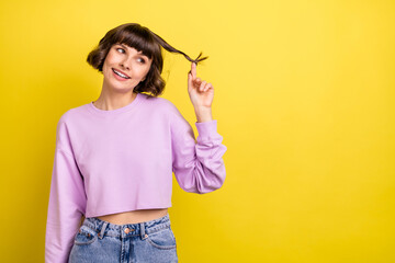 Portrait of attractive girlish cheerful girl thinking copy blank space touching curl isolated over...