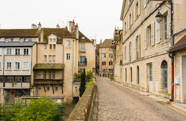 Fototapeta na wymiar Beuatiful view of cobbled ancient street in Dole, France