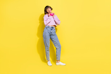 Fototapeta premium Full length body size view of attractive cheerful girl listening hit spending free time isolated over bright yellow color background