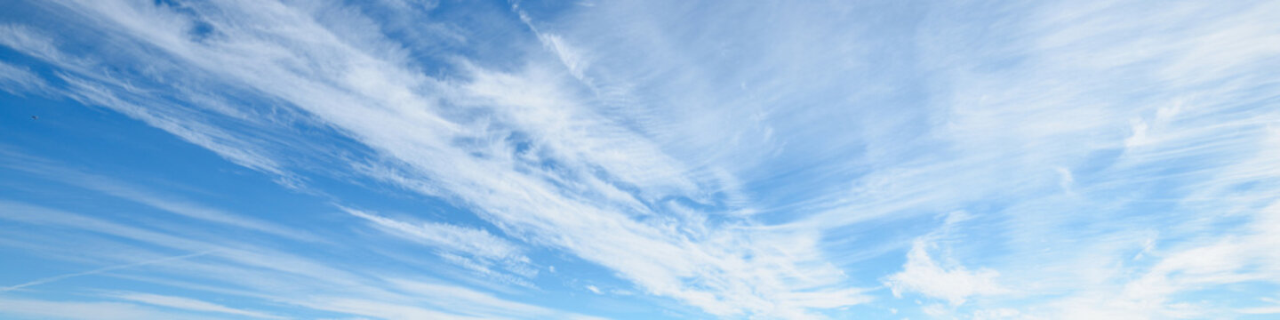 Cloudscape. Clear blue glowing sky. Soft sunlight, cirrus clouds . Panoramic image, texture, background, graphic resources, design, copy space. Meteorology, heaven, hope, peace concept
