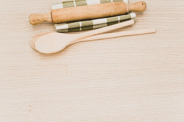natural solid wood kitchen tools and table napkin on a wooden tabletop