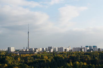 Naklejka premium RUSSIA, MOSCOW: Scenic sunny day landscape view of the city garden with Ostankino tower and blue clouds in the background 