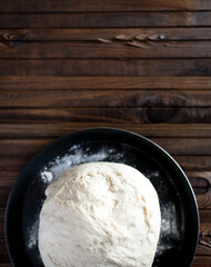 Process of raising the dough in a special basket. Dough made from natural sourdough. Wheat dough. Fermentation. Top view.	
