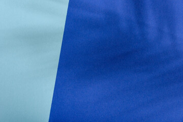 Blue and turquoise color background with tropical palm shadow. Pastel paper and exotic plant shade...