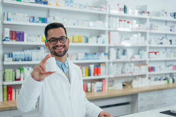 Fototapeta na wymiar Portrait of a handsome pharmacist working in a pharmacy