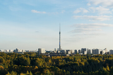 Obraz premium RUSSIA, MOSCOW: Scenic sunny day landscape view of the city garden with Ostankino tower and blue clouds in the background 