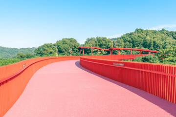 An outdoor park with a red bridge in Shenzhen, China