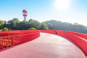 An outdoor park with a red bridge in Shenzhen, China
