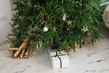 Gift boxes with gifts under the Christmas tree. The concept of New Year and Christmas holidays.